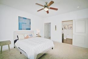 Avon apartment for rent - a bedroom with a large white bed and a ceiling fan