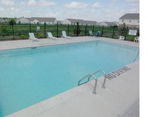 New Haven apartment for rent - A pool with a ladder and chairs around it.