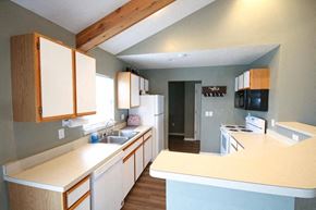 New Haven apartment for rent - A kitchen with wooden cabinets and a white counter.