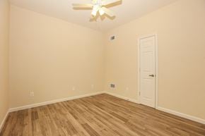 Lindenhurst apartment for rent - a bedroom with a ceiling fan and wood flooring
