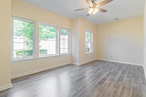 Amityville apartment for rent - an empty living room with wood floors and a ceiling fan
