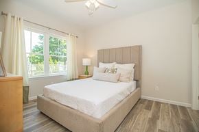 North Babylon apartment for rent - A bedroom with a large bed and a window with curtains.