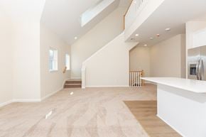 Lindenhurst apartment for rent - A spacious living room with a staircase leading to the upper floor.