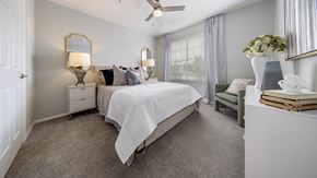 Kissimmee apartment for rent - a bedroom with a bed and a ceiling fan
