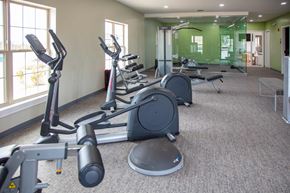Merrillville apartment for rent - A gym with a variety of exercise equipment including treadmills, stationary bikes, and weight machines at Evergreen, Merrillville, 46410