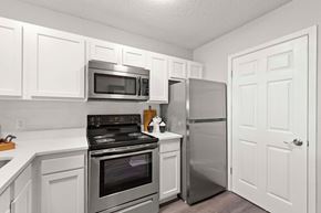 Fort Walton Beach apartment for rent - A kitchen with white cabinets and stainless steel appliances.at Coastline Apartments, Florida, 32547