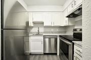 Kansas City apartment for rent - a kitchen with refrigerator and white cabinets at Southridge, Kansas City, Kansas