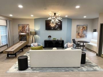Merrillville apartment for rent - A modern living room with a white sofa and a black coffee table.