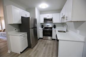 Merrillville apartment for rent - A kitchen with white cabinets and stainless steel appliances. at Evergreen, Merrillville