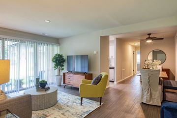 Richmond apartment for rent - A living room with a yellow chair and a round table.
