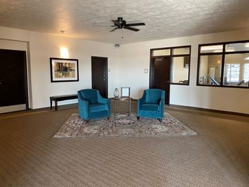 Mitchell apartment for rent - a living room with two blue chairs and a table