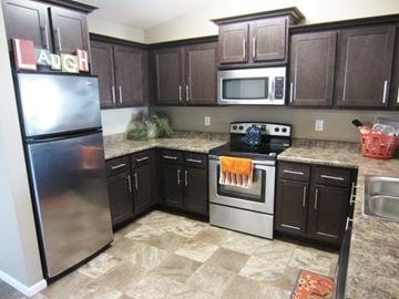 Mitchell apartment for rent - a kitchen with stainless steel appliances and brown cabinets