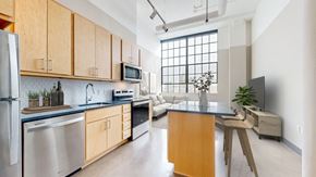 Minneapolis apartment for rent - a kitchen with wooden cabinets and stainless steel appliances and a counter top