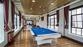 Minneapolis apartment for rent - a games room with a pool table in the middle of it