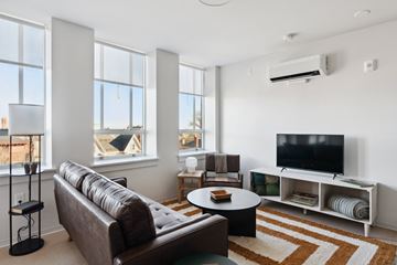 Portland apartment for rent - a living room with a couch and a coffee table and a television
