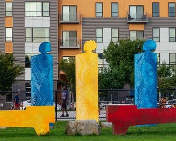 Portland apartment for rent - three sculptures in the grass in front of an apartment building