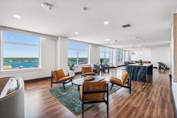 Portland apartment for rent - a living room with a table and chairs and large windows