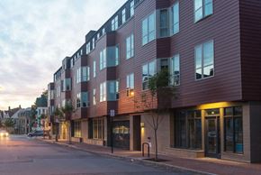 Portland apartment for rent - a new building on a city street at dusk