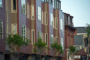 Portland apartment for rent - a row of houses with red and gray siding on a city street