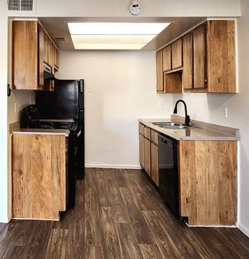 Phoenix apartment for rent - a kitchen with wooden cabinets and a stove and a refrigerator