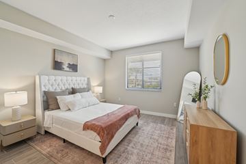 Pompano Beach apartment for rent - A bedroom with a large bed and a wooden dresser.