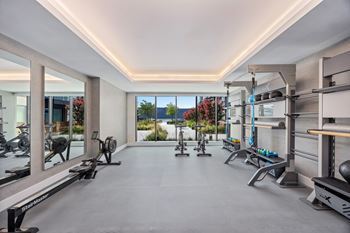 Modern gym with a variety of equipment and a view of the outdoors
