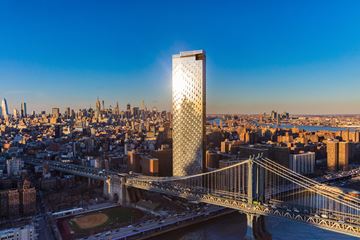 New York apartment for rent - a tall skyscraper overlooking a city with the brooklyn bridge