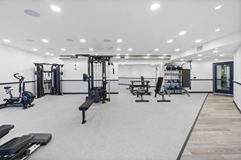 A spacious gym with a variety of equipment including treadmills, weights, and exercise machines.