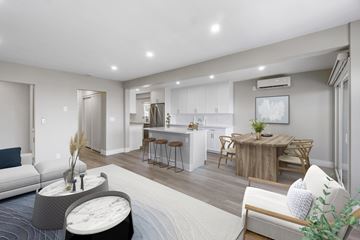 Laguna Beach apartment for rent - A modern living room with a grey sofa and a wooden coffee table.