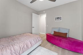 Carlsbad apartment for rent - A bedroom with a pink bed and a pink bench at Tamarack Sands Apartment Homes, Carlsbad, 92008