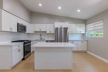 Costa Mesa apartment for rent - A kitchen with white cabinets and a large island.