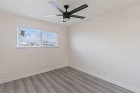 San Clemente apartment for rent - a bedroom with a ceiling fan and a window at Seaview Terrace Apartment Homes, San Clemente, California