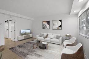 Torrance apartment for rent - A modern living room with a white sofa, a glass coffee table, and a TV.