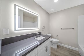 West Covina apartment for rent - a bathroom with a large mirror and a sink and a toilet at Wescove Apartments, West Covina