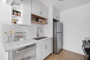 Torrance apartment for rent - A modern kitchen with white cabinets and stainless steel appliances.