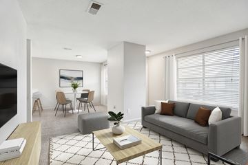 Benbrook apartment for rent - A living room with a grey couch, a coffee table, and a painting on the wall.