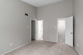 Raleigh apartment for rent - a bedroom with a carpeted floor and a door to a closet at Anson at North Hills, Raleigh