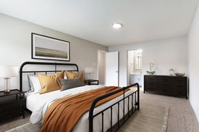 Rocky Mount apartment for rent - A bedroom with a large bed and a painting on the wall.