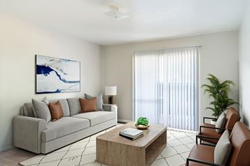 Dallas apartment for rent - A living room with a grey couch, a coffee table, and a painting on the wall.