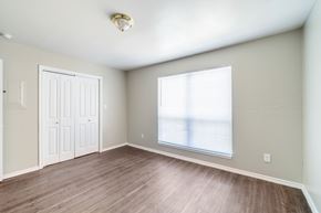Dallas apartment for rent - A room with a white door and a window with blinds.