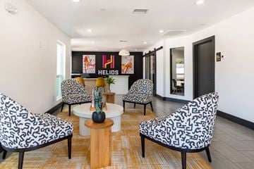 Dallas apartment for rent - A living room with a patterned chair and a coffee table.