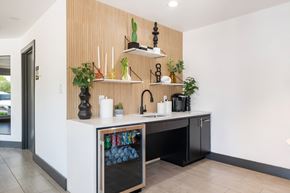 Dallas apartment for rent - A kitchen with a white counter and a wooden panel on the wall. at Helios, Dallas