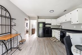 Jacksonville apartment for rent - A kitchen with white cabinets and a black oven.at Lauradale, North Carolina