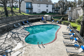 Arlington apartment for rent - A small pool surrounded by chairs and a stone wall.