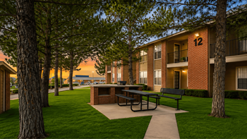 Community courtyard with picnic table and brick grill