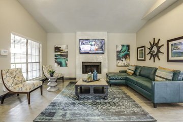 Mesquite apartment for rent - A living room with a fireplace and a television on the wall.