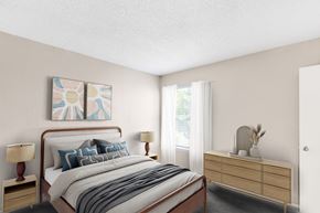 Arlington apartment for rent - A bedroom with a bed, nightstand, and a painting on the wall.
