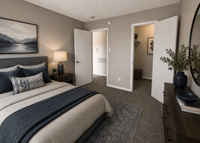 Dallas apartment for rent - A bedroom with a large bed and a painting on the wall.