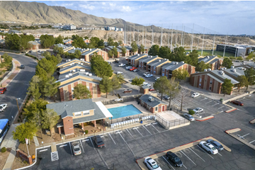 El Paso apartment for rent - A parking lot with a building and a pool.