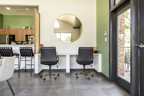 Fayetteville apartment for rent - A modern kitchen with a white countertop and black chairs. at Channing, North Carolina